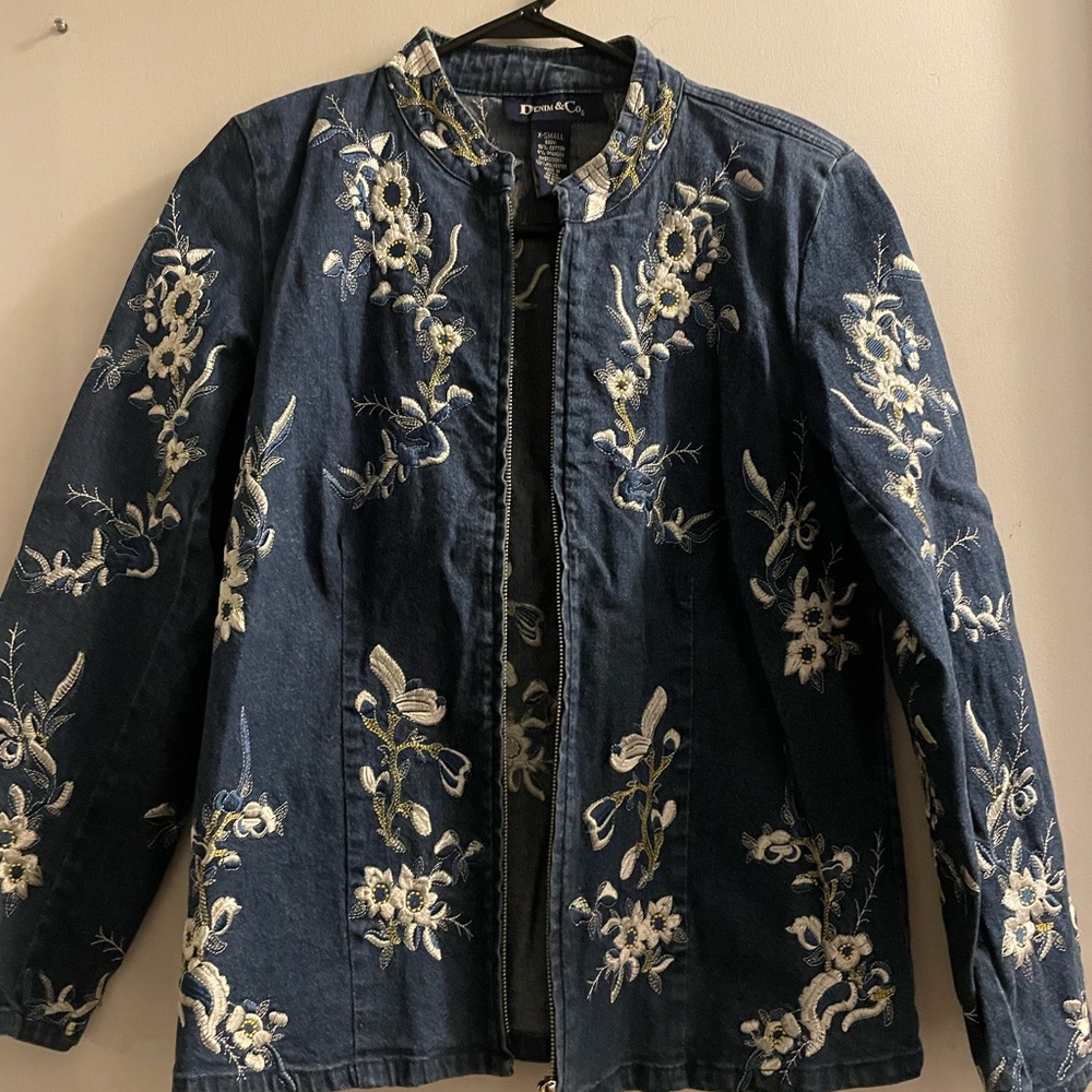 Denim jacket with scattered flower print.